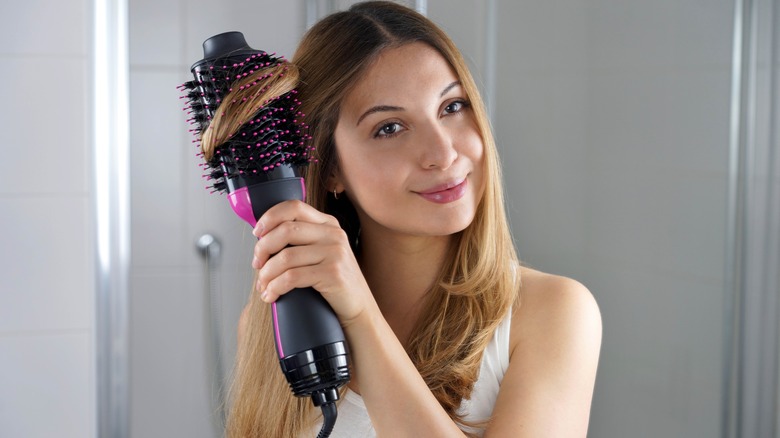 A woman using a hot air brush