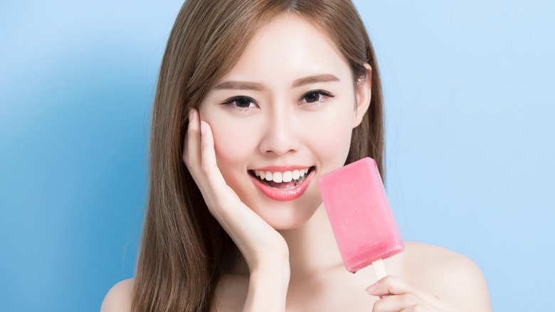 Woman eating popsicle 