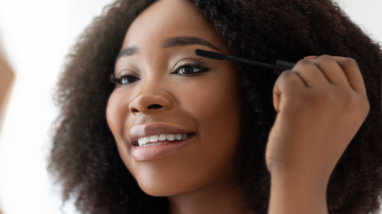 Woman applying mascara 