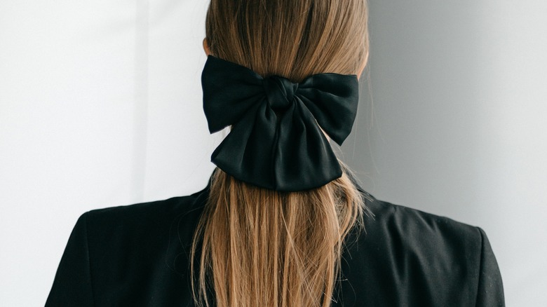 ponytail tied with black bow