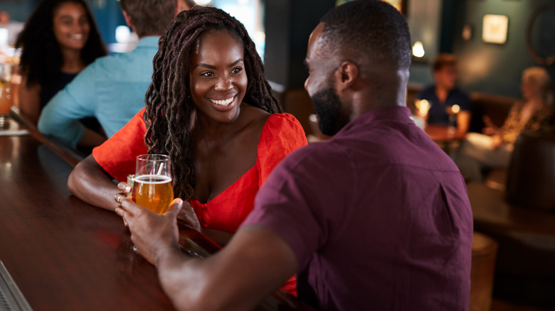 Young couple smiling at bar