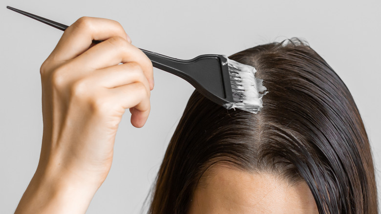 Woman highlighting hair at home