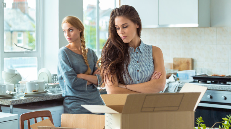 tense women with moving boxes