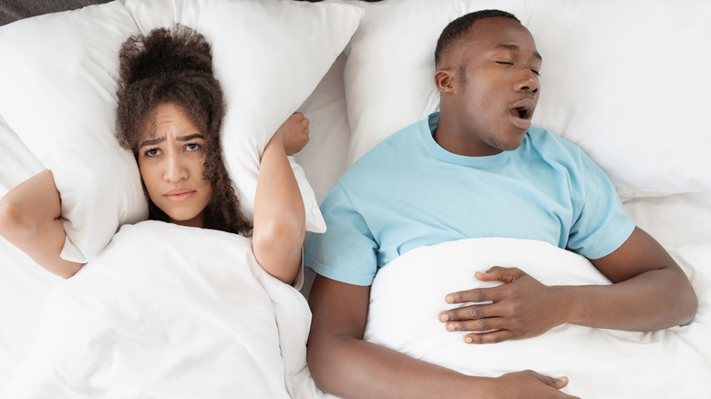 Married couple struggling with snoring 