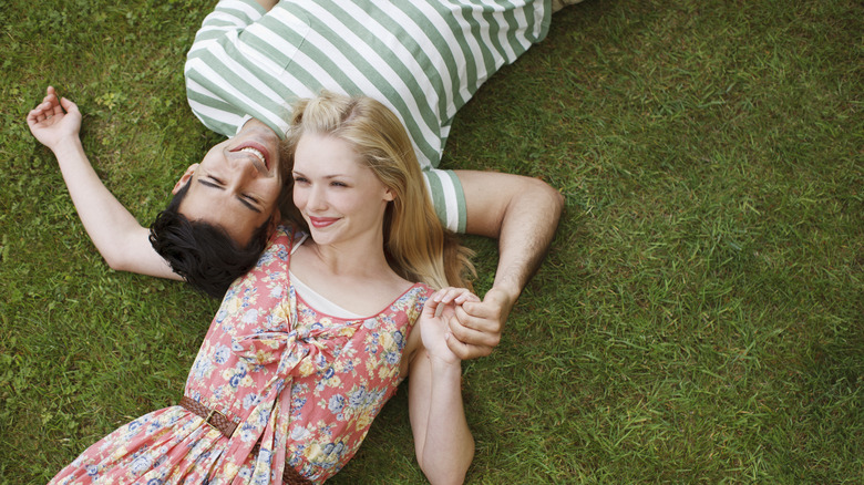 Couple laying on grass