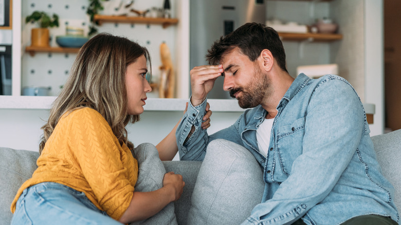 Woman comforting man