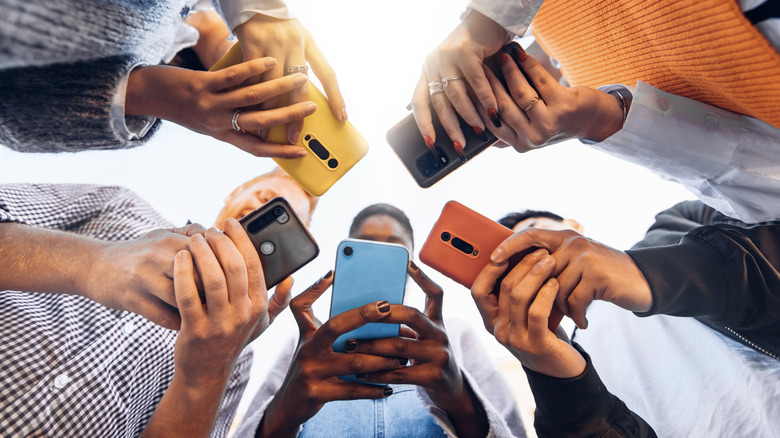 people standing with phones