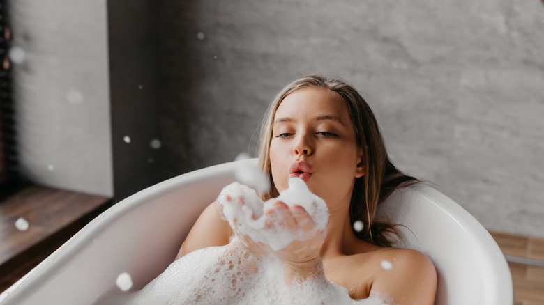 Woman soaks in bubble bath