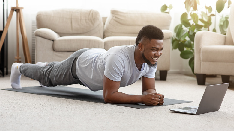 man holding a yoga plank