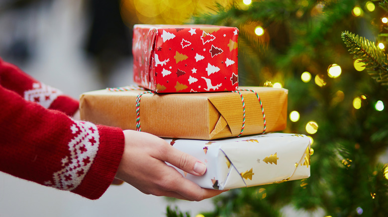 Woman's hands holding holiday Christmas gifts