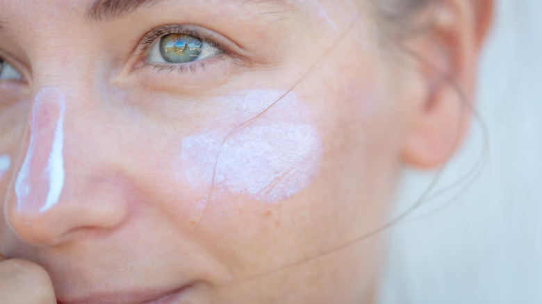 smiling woman wearing sunscreen