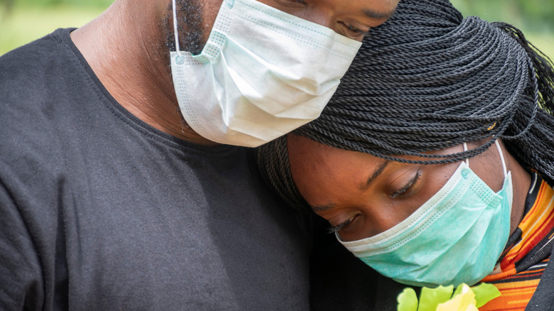 Couple mouring with face masks