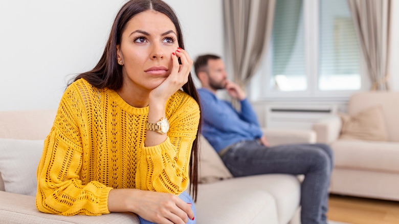 woman uncertain with man in room