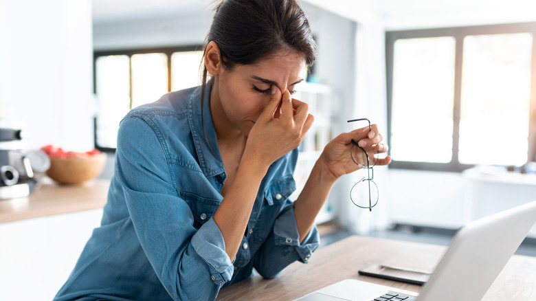 Worried woman researching on laptop