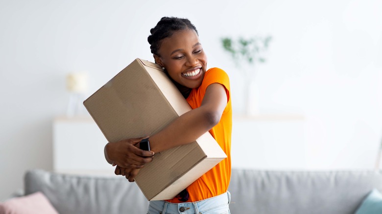 woman hugging package