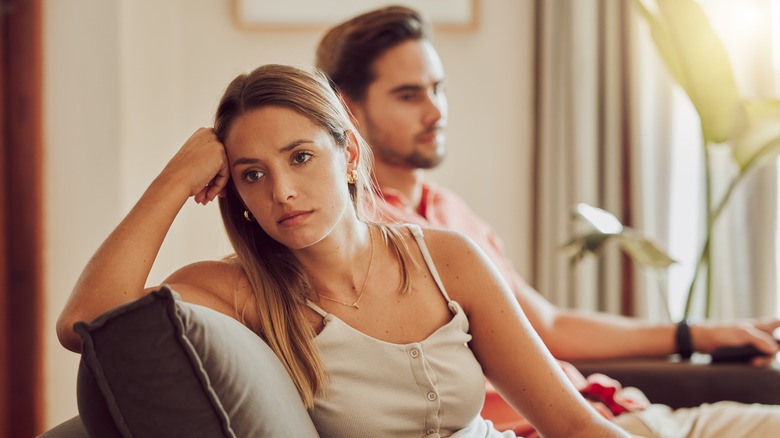 couple feeling tense on couch 
