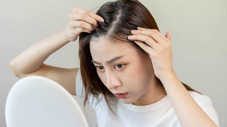 Woman looking at her scalp