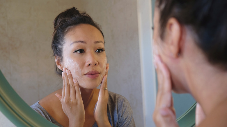 Woman applying skin product to her face