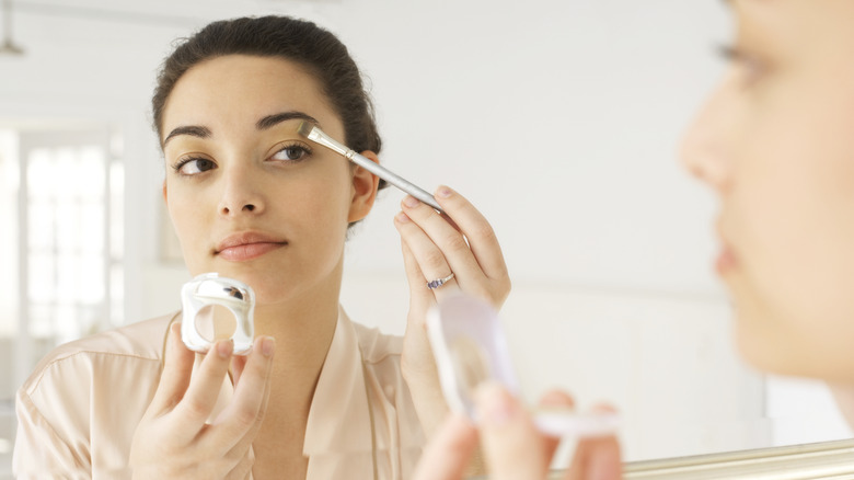 A woman applying makeup