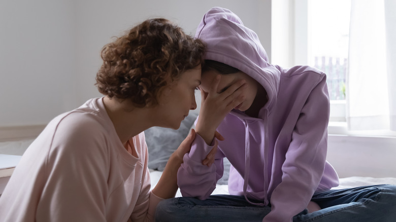 women talking sadly