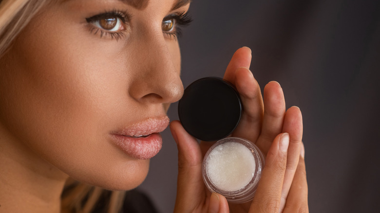 Woman using lip scrub