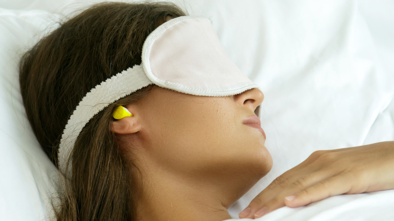 woman sleeping with earplugs