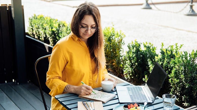 Woman writing in mood tracking journal