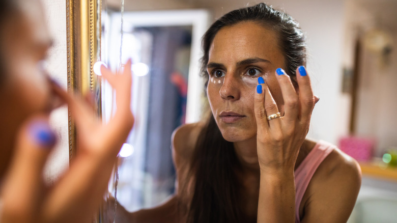 Girl applying concealer