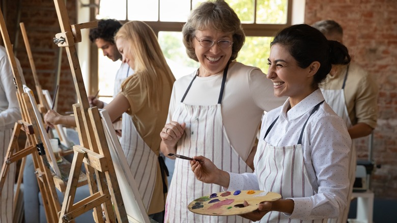student in art school with teacher 