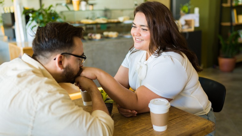 Man kissing woman's hand