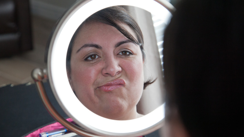 woman deciding on makeup