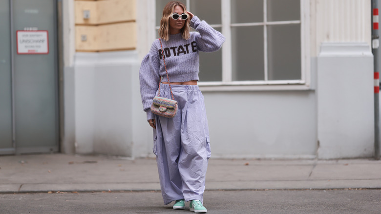 Woman in purple sweater and pants