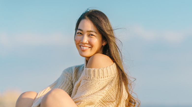 woman in sweater on beach
