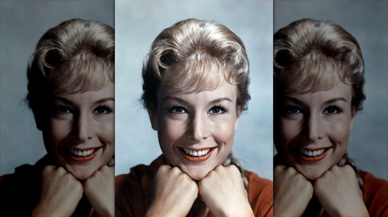 Barbara Eden smiles with a micro fringe and red lipstick