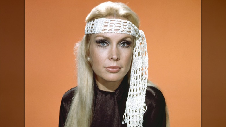 Barbara Eden poses wearing a crochet white headband