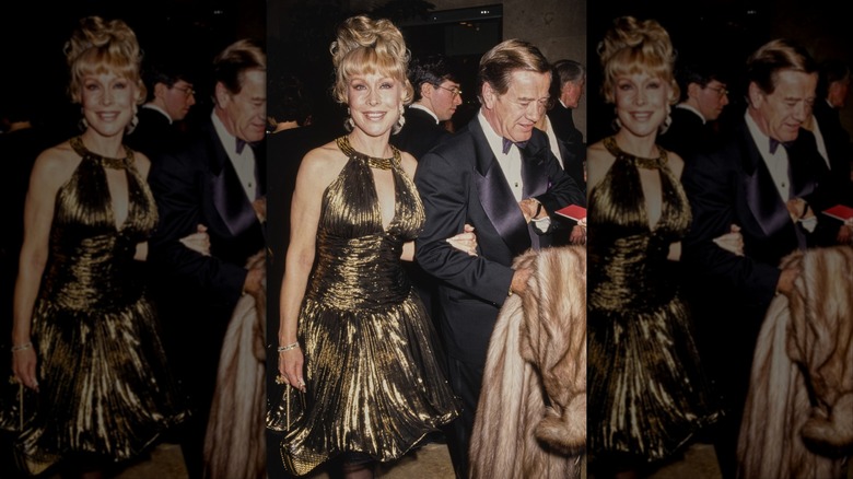 Barbara Eden smiling wearing a gold dress