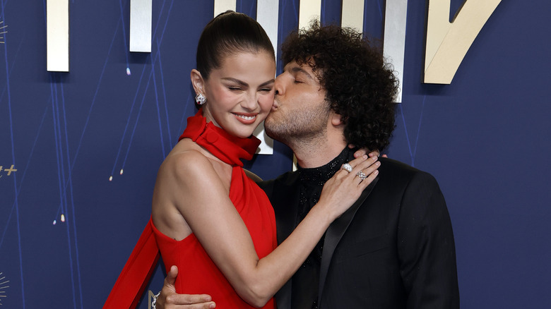 Benny Blanco kisses Selena Gomez on the cheek during a red carpet event in 2025