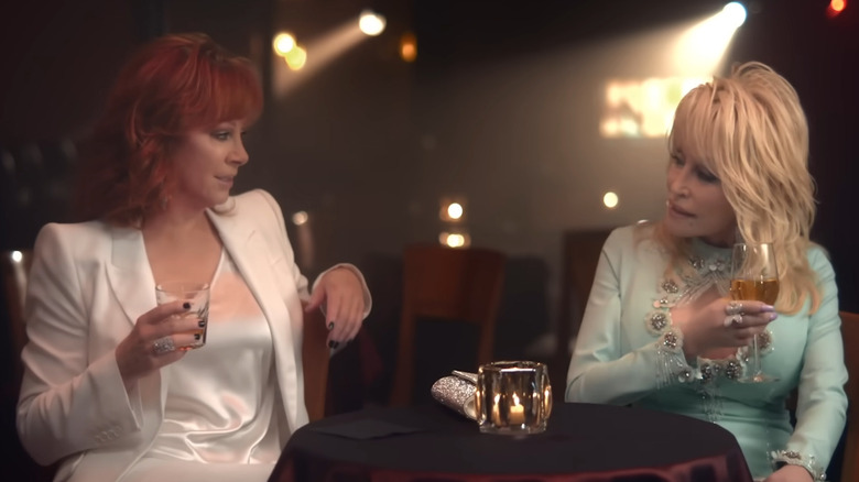 Reba McEntire and Dolly Parton in the Does He Love You music video