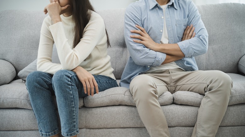 Couple sitting couch away each other