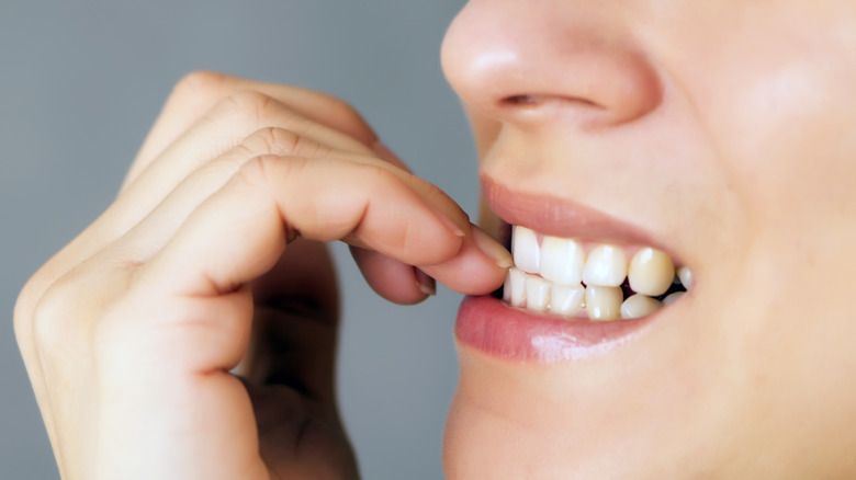 person biting their nails