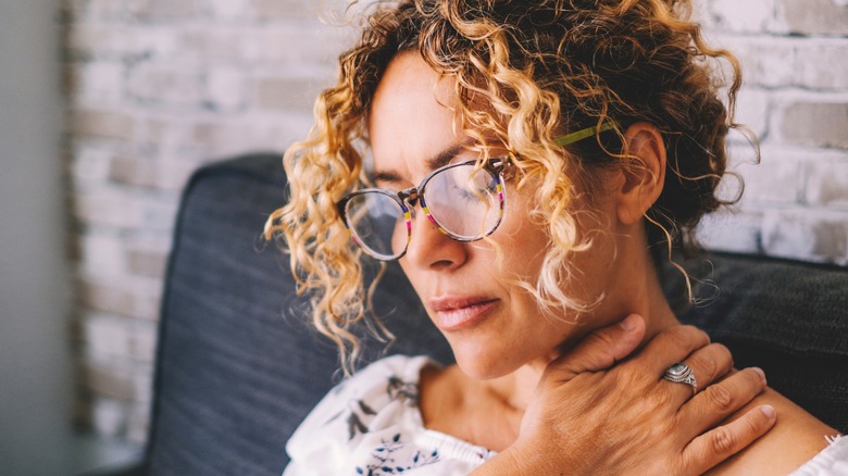 Stressed woman reflecting in chair