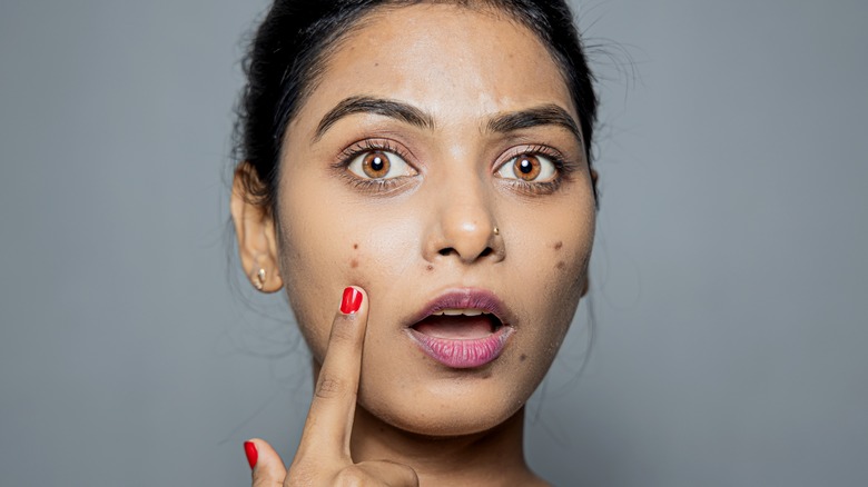 woman points at breakout with a shocked face