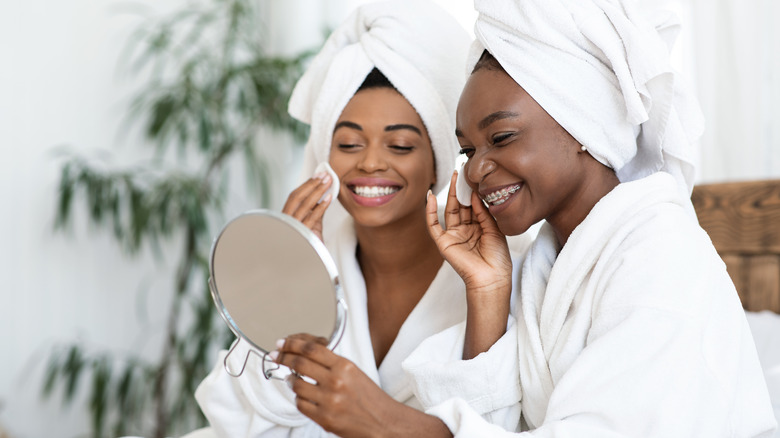 girls applying toner to face