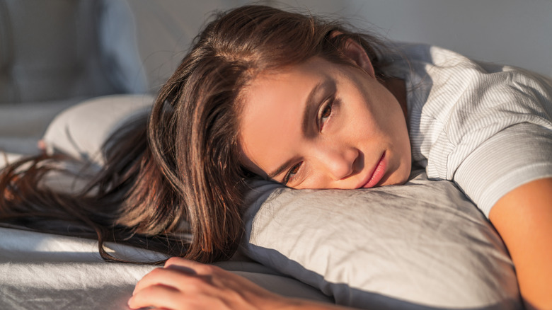 woman tired in bed