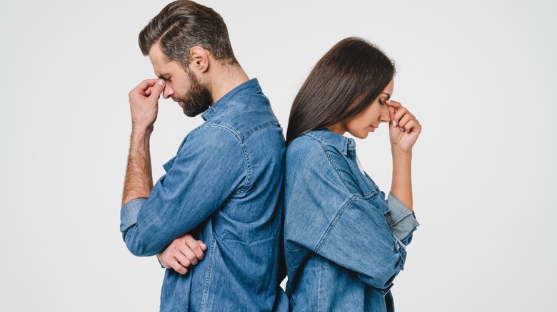 Frustrated couple stands back to back