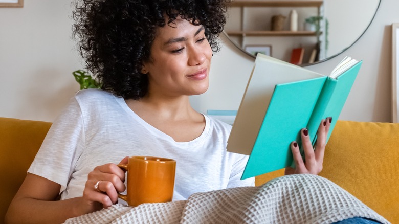 Smiling woman reading book