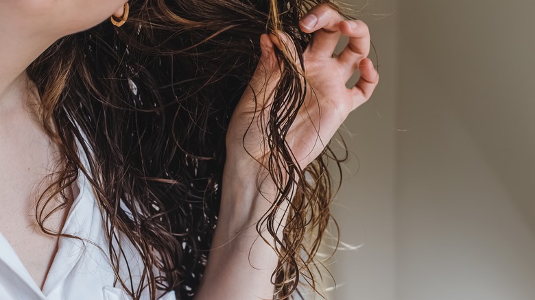 woman feeling wet hair 