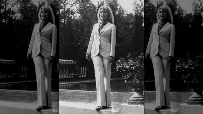 Ingrid Pitt poses wearing a white suit