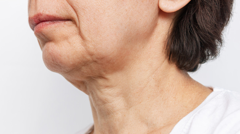 Model examining skin on face
