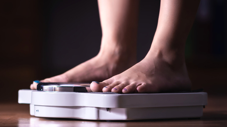 Model standing on scale